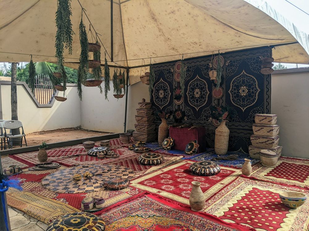 Traditional marriage setting with rugs, baskets and woven décor under a tent